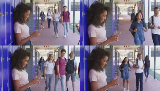 黑人少女在学校走廊使用智能手机高清在线视频素材下载