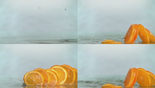 橙子碰到橙汁表面，切成两半。慢动作镜头高清在线视频素材下载