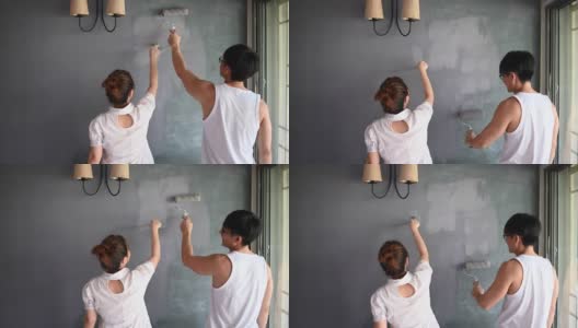 一对亚洲华人夫妇正在粉刷他们的房子高清在线视频素材下载