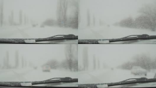 高速公路上有警笛和闪烁着蓝色灯光的警车，在冬天挡风玻璃上有水滴高清在线视频素材下载
