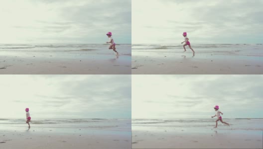 小女孩在沙滩上跑步高清在线视频素材下载