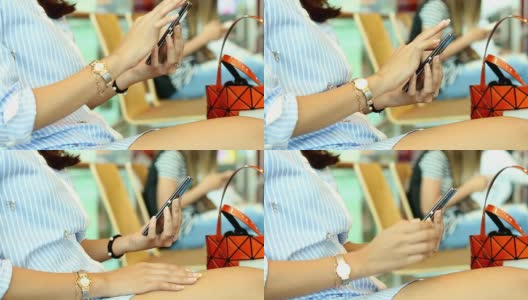 女子在机场使用手机。高清在线视频素材下载