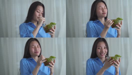 面部表情由年轻女子在清纯的清晨时分，吃着沙拉，好手势高清在线视频素材下载