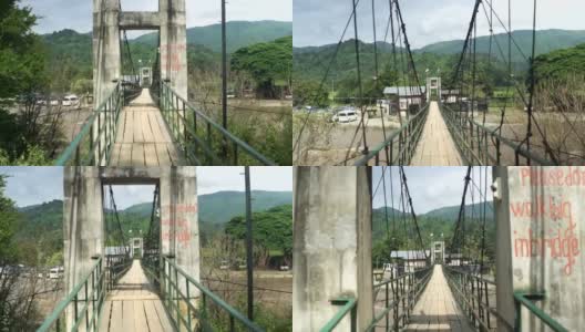 在Vang Vieng的一座混凝土悬吊桥上行走高清在线视频素材下载