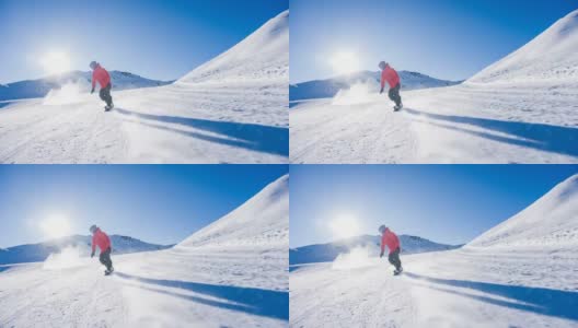 在一个阳光明媚的日子里，滑雪者从滑雪坡上滑下来，雪花向他喷来高清在线视频素材下载