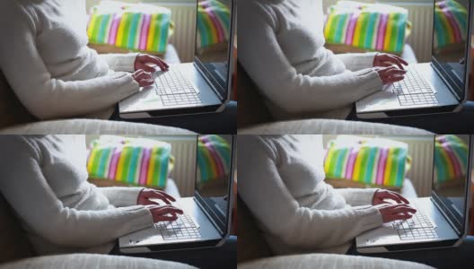 膝上放着笔记本电脑的女人高清在线视频素材下载