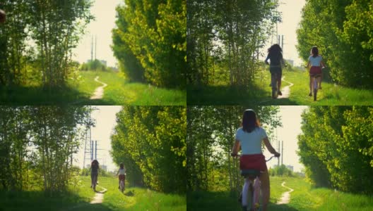 女朋友骑车离开绿油油的灌木丛，一个阳光灿烂的日子高清在线视频素材下载
