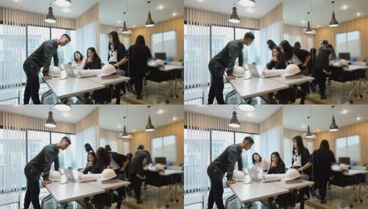 亚洲商人和团队工程师在会议上用笔记本给商业伙伴讨论文件和想法，商务女性在工作中微笑高清在线视频素材下载
