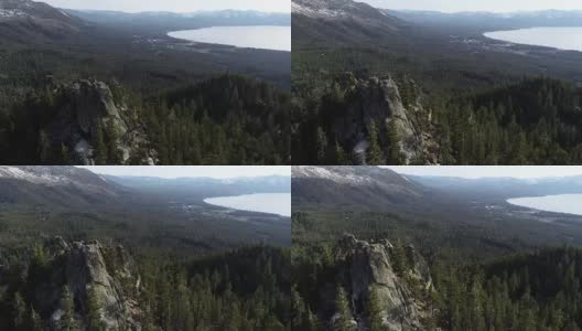 环绕城堡岩石与雪顶内华达山脉太浩湖，加州荒野的无人机视野高清在线视频素材下载