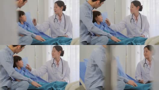 微笑的医生在医院为她的病人测量女婴的体温。医疗保健:照顾高清在线视频素材下载
