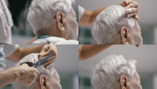 冠状病毒隔离:在家里给孙女剪头发的老年妇女高清在线视频素材下载
