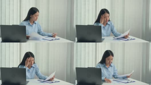 亚洲女性经理是压力和头痛错误的工作文件在她的办公室。高清在线视频素材下载