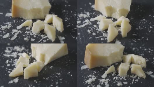 硬邦邦的帕尔玛干酪放在黑色的石头盘子里。板旋转,特写高清在线视频素材下载