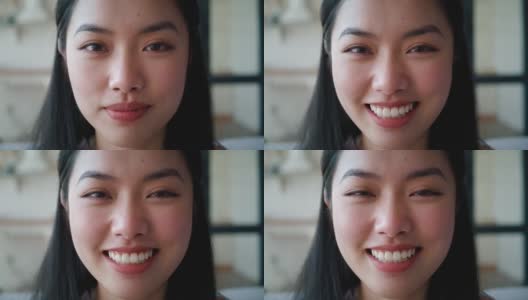 特写镜头。漂亮的年轻亚洲女人微笑着对着相机摆姿势的短发自信的脸肖像。专注于一个安详的女人的平静的表情，带着牙齿的微笑，自信地看着镜头高清在线视频素材下载