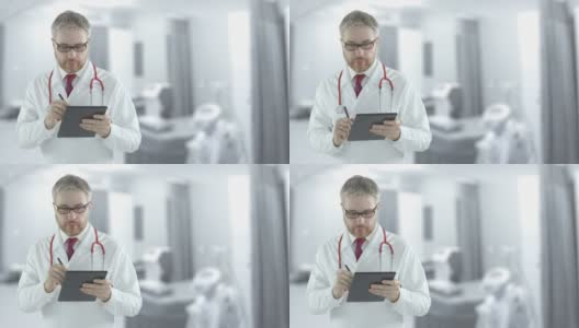 专注的医生在病房的平板电脑上填写清单。用红色相机拍摄高清在线视频素材下载