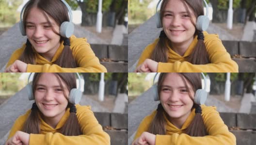 一个13岁的少女一边听音乐一边大笑。2021年11月12日，乌克兰扎波罗热高清在线视频素材下载