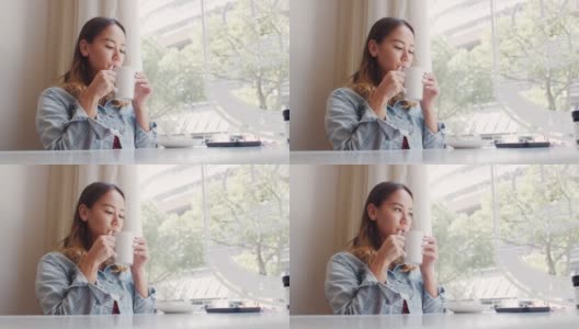 一个迷人的年轻女子在她最喜欢的咖啡馆享受咖啡的4k视频片段高清在线视频素材下载
