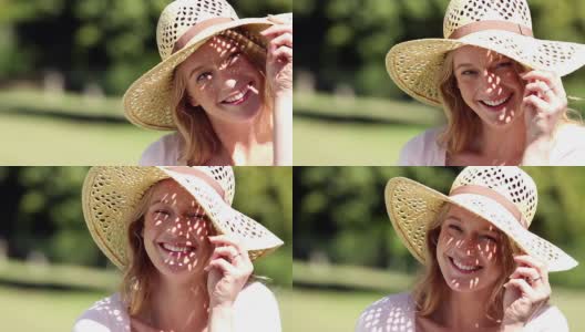 快乐的女孩戴着草帽对着镜头微笑高清在线视频素材下载
