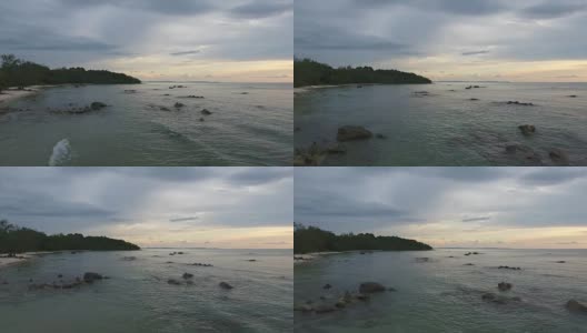 海面和岩石海滩在黄昏，航拍视频高清在线视频素材下载