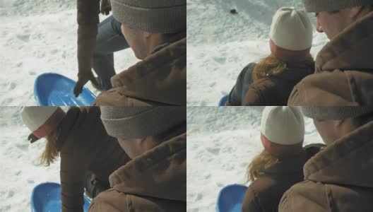 在一个年轻女人上雪橇的肩膀镜头高清在线视频素材下载