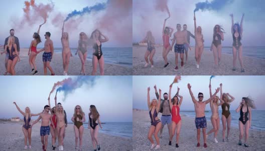 暑假，一群青年男女手捧七彩烟沿着海滨散步高清在线视频素材下载