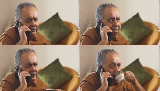 一位老人一边喝茶一边打电话高清在线视频素材下载