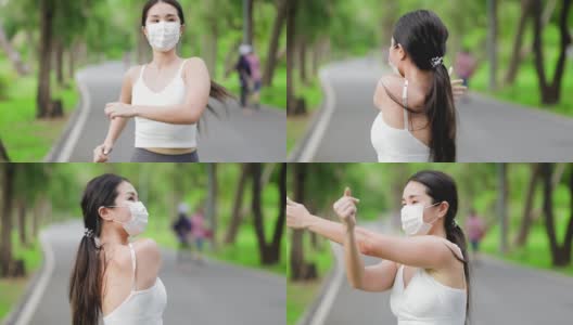 covid-19大流行期间，亚洲跑步者在公园慢跑。在冠状病毒时期锻炼。健康女性户外慢跑，健康生活理念。她脸上戴着防毒面具。高清在线视频素材下载