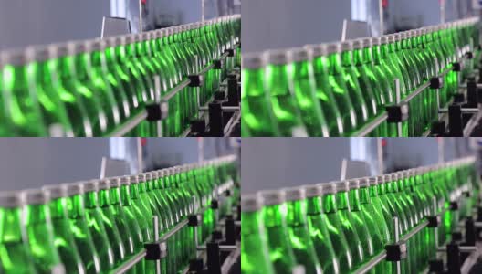 绿色矿泉水瓶沿着自动生产线移动。高清在线视频素材下载