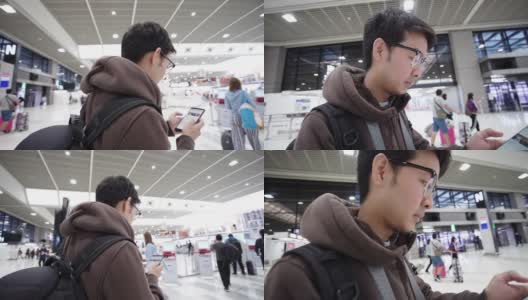 一名男子在机场用智能手机办理登机手续。高清在线视频素材下载