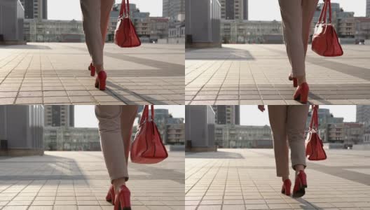 穿着红色高跟鞋的女腿漫步在现代化的城市里高清在线视频素材下载