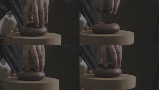 工匠在宜兴陶壶上试盖。为中国茶道制作的手工陶壶。褐色陶器茶壶。4 k的视频。59.94帧/秒高清在线视频素材下载
