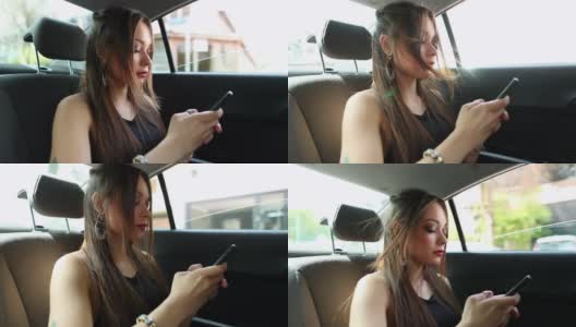一个西班牙女孩在车后座上用手机发短信。一名拉丁年轻女子在出租车上用智能手机发信息高清在线视频素材下载