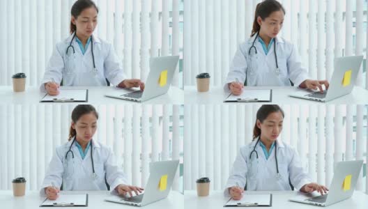 一名年轻的亚洲医生在医院用笔记本电脑工作的4K视频高清在线视频素材下载