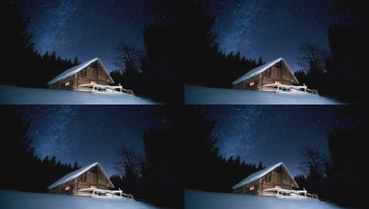 美丽的木屋在冬天的森林里闪烁的星星下。Cinemagraph。高清在线视频素材下载