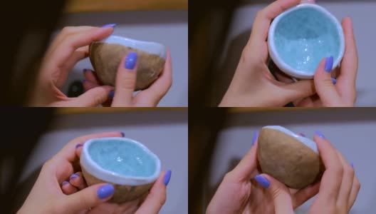 在陶艺作坊检查瓷杯的职业妇女陶工高清在线视频素材下载