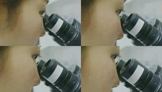 在医院实验室里摆弄显微镜的女科学家技术员高清在线视频素材下载