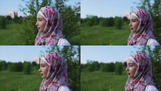 一个年轻的穆斯林妇女戴着头巾，在公园里享受孤独高清在线视频素材下载
