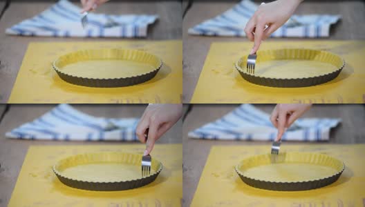 用叉子在糕点盒底部戳个孔。制作苹果馅饼系列。高清在线视频素材下载