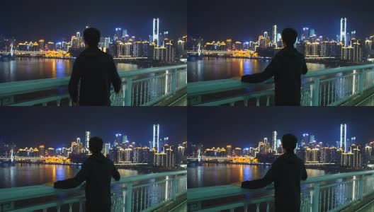 在重庆，一个年轻人看着城市的轮廓线高清在线视频素材下载