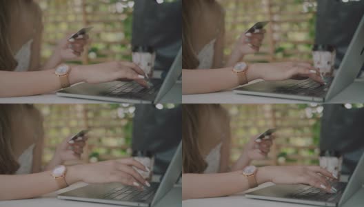 一名女子用信用卡在酒店咖啡厅的平板电脑上在线购物高清在线视频素材下载