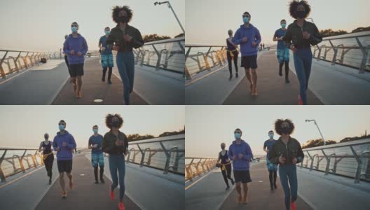 一群朋友早上跑步，脸上戴着防护面具，慢动作。冠状病毒保护的概念高清在线视频素材下载
