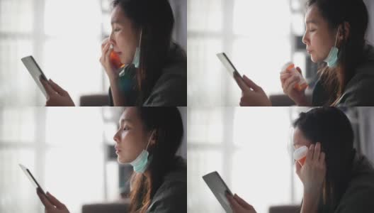 生病的年轻亚洲妇女与她的医生在数字平板电脑在家里交谈高清在线视频素材下载