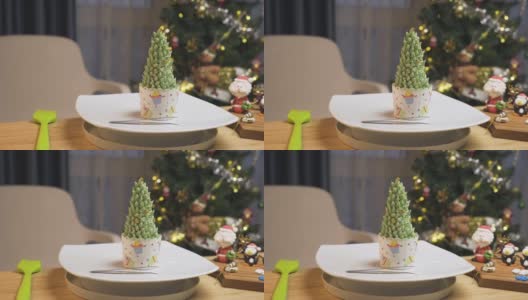 多利·shot:圣诞奶油树纸杯蛋糕，用彩色糖霜和金色的星星装饰，圣诞老人和企鹅用糖霜做的甜点。高清在线视频素材下载