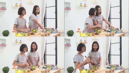 母女在厨房做饭在家，幸福家庭亚洲概念高清在线视频素材下载