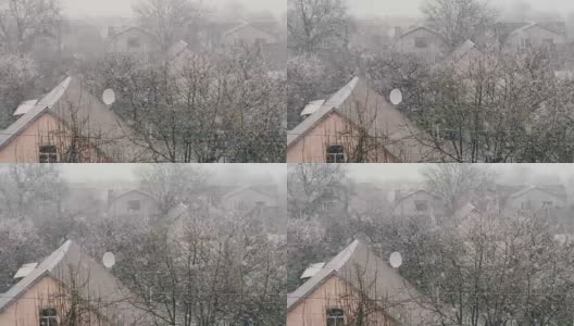 在春天雪。雪花落在枝繁叶茂的街道上。高清在线视频素材下载