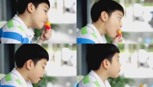 亚洲小孩喜欢吃彩虹冰淇淋。高清在线视频素材下载