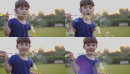 一个可爱可爱的小女孩正在吹肥皂泡，一个美丽快乐的特写镜头高清在线视频素材下载