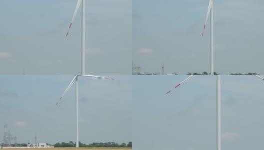 风力发电机组在现场对着变电站旋转高清在线视频素材下载