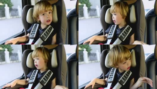可爱的孩子坐在车里高清在线视频素材下载