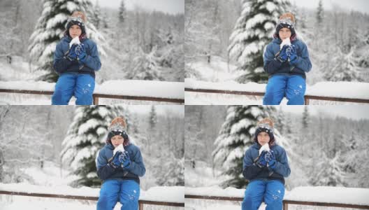 可爱的小男孩在冬天吃雪高清在线视频素材下载